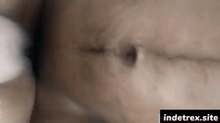 Couple on a made bed in an explicit scene