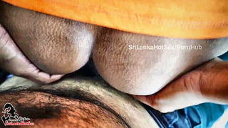 Amateur couple on a living room sofa in explicit scene