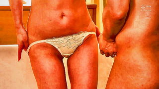 Explicit massage scene in a softly lit room