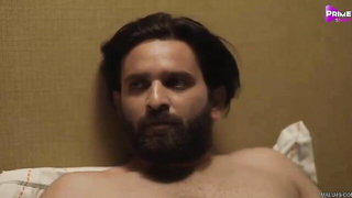 Couple mid-scene in a dim bedroom