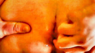 Amateur couple on a living room sofa in explicit scene