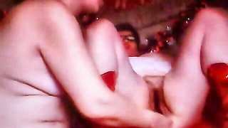 Amateur couple on a living room sofa in explicit scene