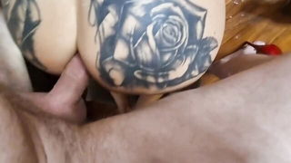 Couple on a made bed in an explicit scene