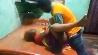 Couple on a made bed in an explicit scene