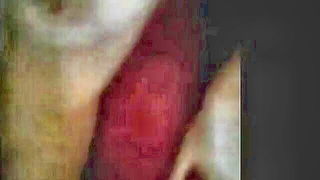 Amateur couple on a living room sofa in explicit scene