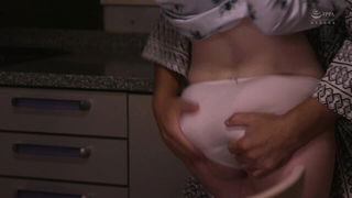 Couple on a patterned bedspread in an explicit scene