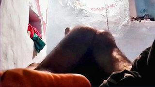 Couple on a made bed in an explicit scene