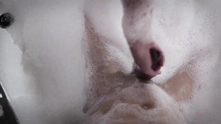 Explicit massage scene in a softly lit room
