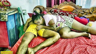 Couple on a patterned bedspread in an explicit scene