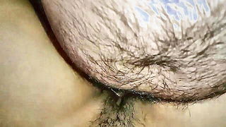 Amateur couple on a living room sofa in explicit scene