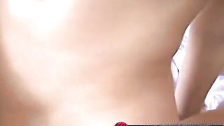 Explicit massage scene in a softly lit room