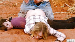 Couple on a made bed in an explicit scene