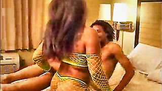 Studio set with performers in an explicit scene under bright lights