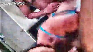Couple on a made bed in an explicit scene