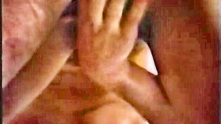 Explicit massage scene in a softly lit room