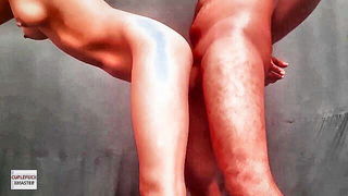 Couple on a made bed in an explicit scene