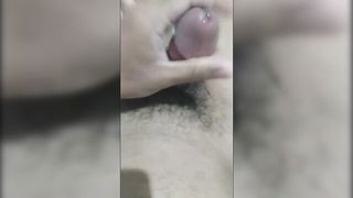 Solo performer with a toy on rumpled bedsheets