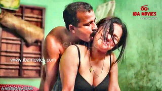 Couple on a made bed in an explicit scene