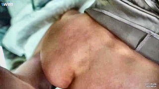 Couple on a made bed in an explicit scene