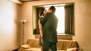 Couple on a made bed in an explicit scene