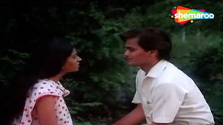 Couple mid-scene in a dim bedroom