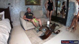 Couple on a made bed in an explicit scene