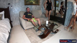 Couple on a made bed in an explicit scene