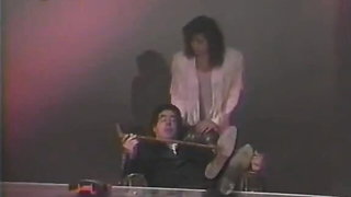 Explicit massage scene in a softly lit room