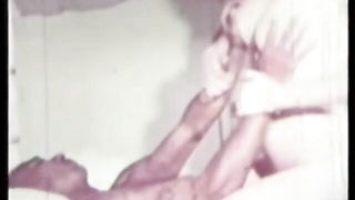Solo performer with a toy on rumpled bedsheets