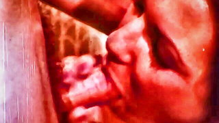 Explicit massage scene in a softly lit room