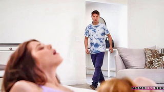 Couple on a made bed in an explicit scene