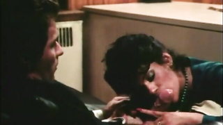 Couple on a patterned bedspread in an explicit scene