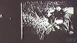 Couple mid-scene in a dim bedroom