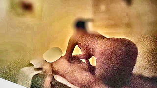 Solo performer with a toy on rumpled bedsheets