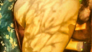 Couple on a made bed in an explicit scene