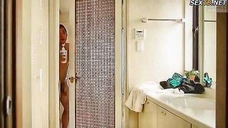 Explicit massage scene in a softly lit room