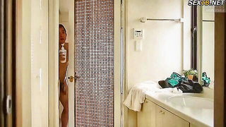 Explicit massage scene in a softly lit room