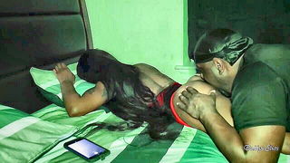 Couple on a patterned bedspread in an explicit scene