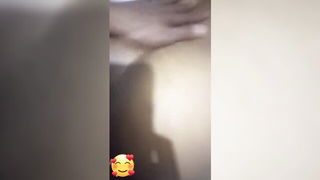 Couple on a made bed in an explicit scene