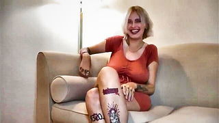 Amateur couple on a living room sofa in explicit scene