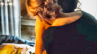 Explicit doggy style scene on a wide bed