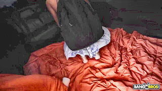 Couple on a made bed in an explicit scene