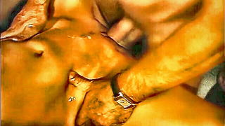 Couple on a patterned bedspread in an explicit scene