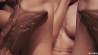 Couple on a made bed in an explicit scene