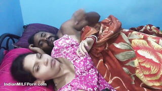 Couple on a made bed in an explicit scene