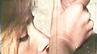 Couple on a made bed in an explicit scene