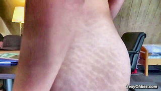Amateur couple on a living room sofa in explicit scene