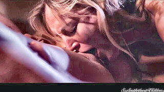 Couple mid-scene in a dim bedroom