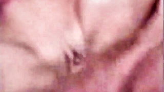 Couple on a patterned bedspread in an explicit scene