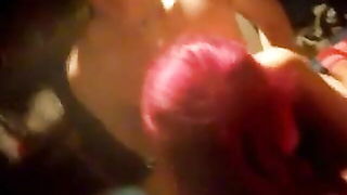 Solo performer with a toy on rumpled bedsheets